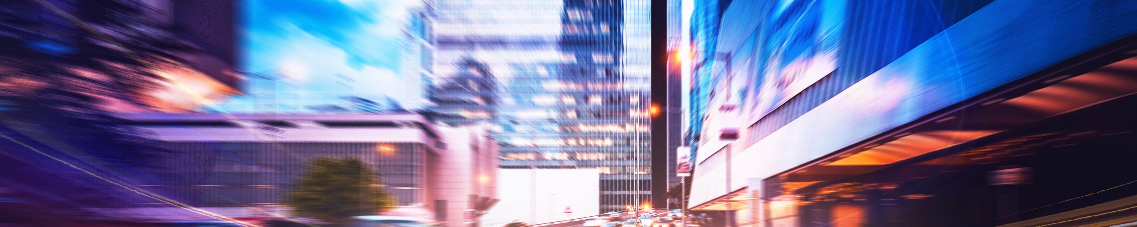 Long exposure photo of cars driving a curving highway in the city