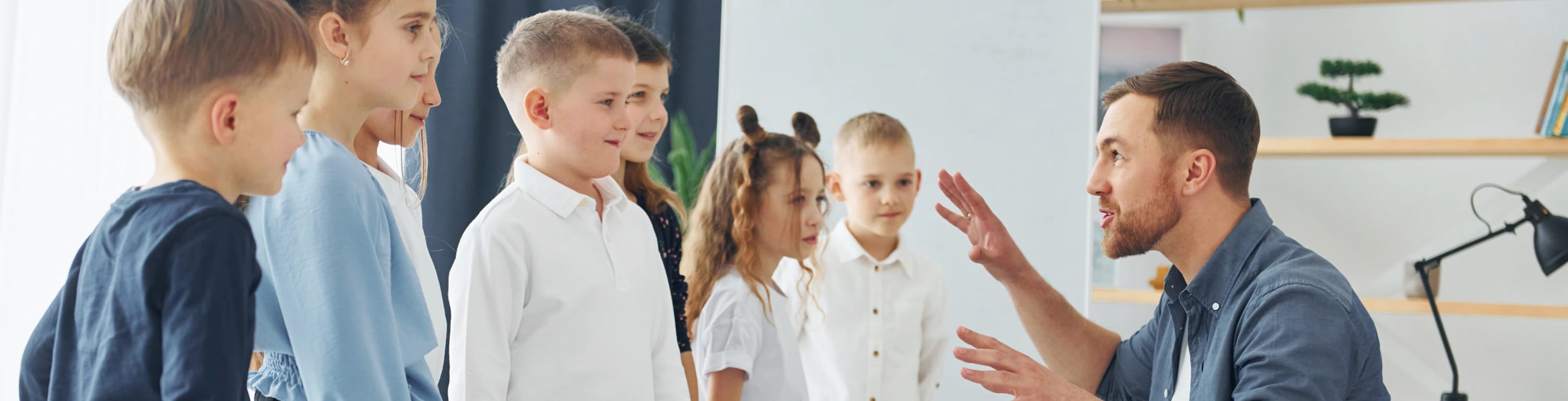 Man telling a story to a group of children