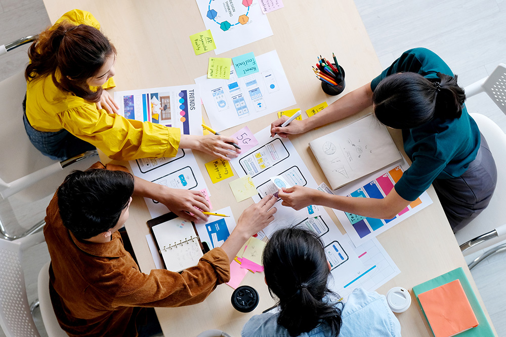 Overhead shot of a small team doing user experience planning {3000x2000}