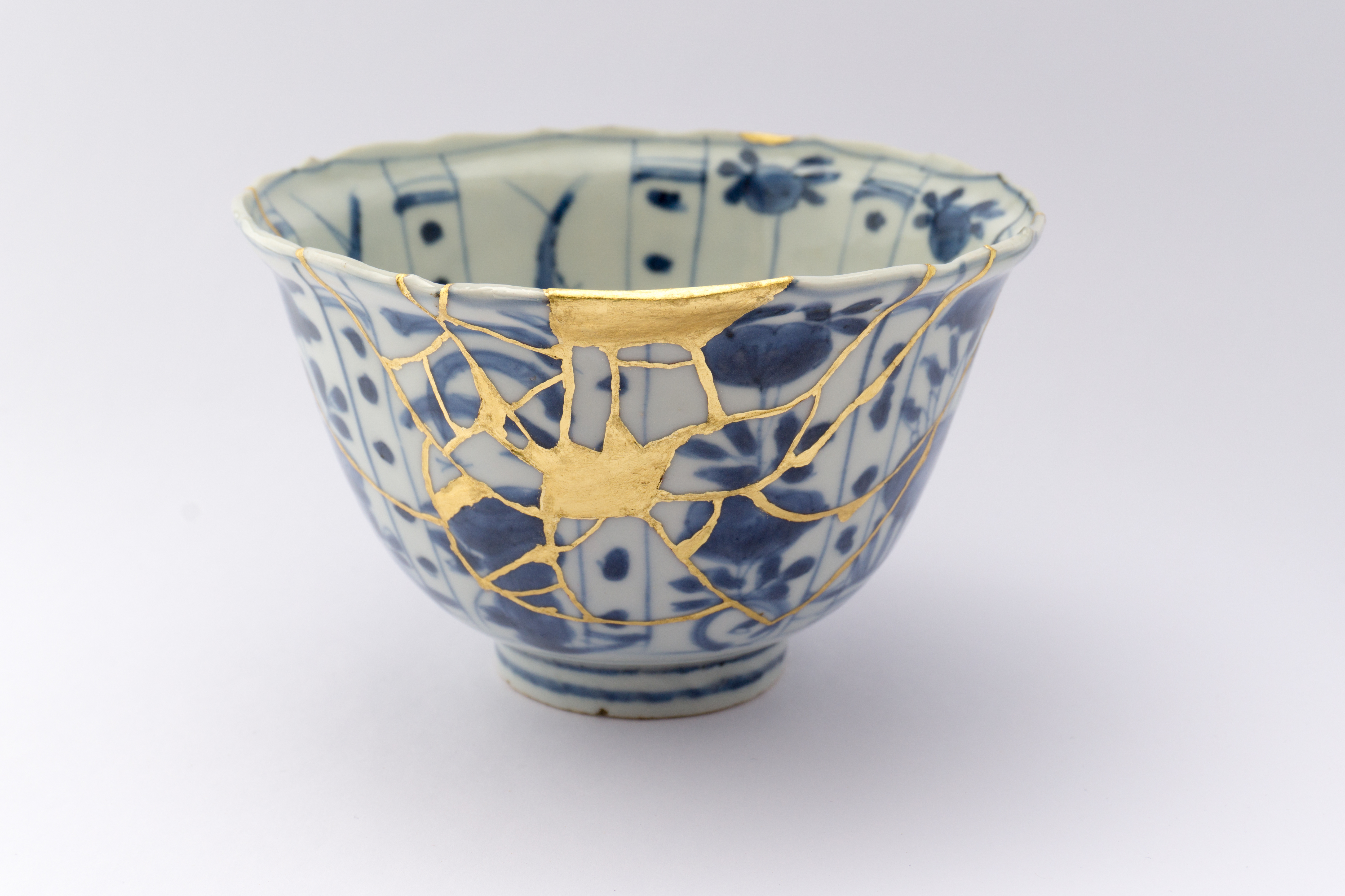 Cracked porcelain bowl repaired with gold {1000x667} 