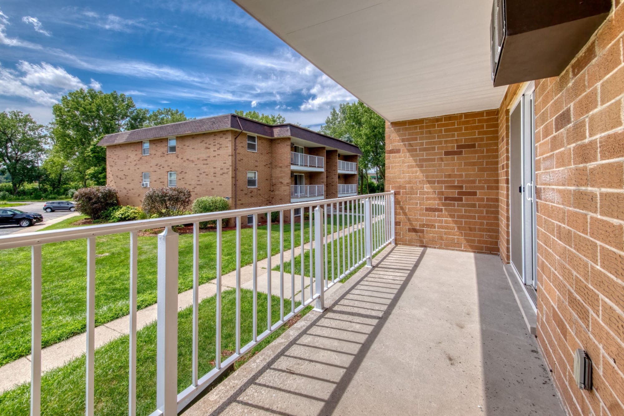 Balcony overlooking the lawn and neighboring building