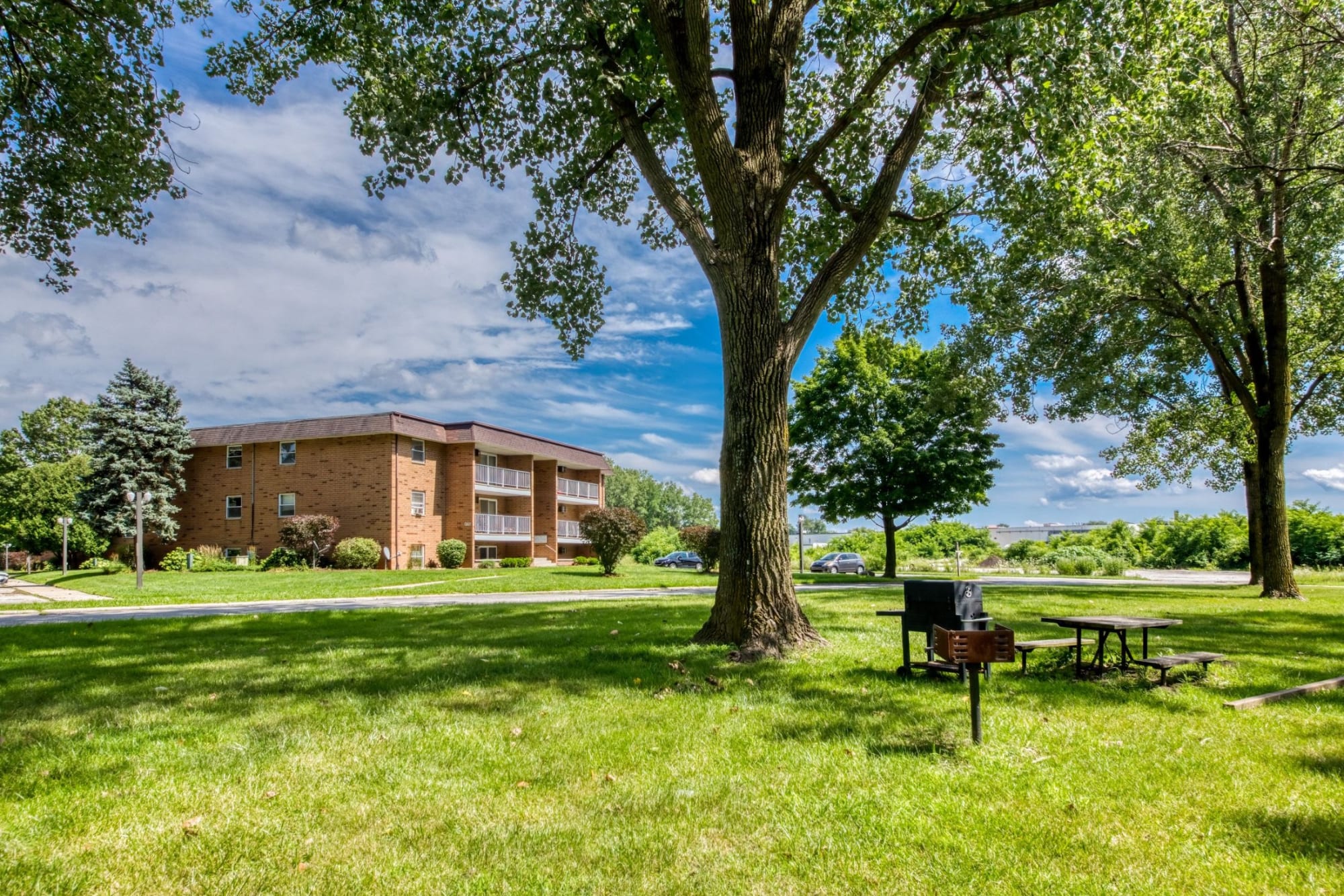 Brick building beneath mature trees