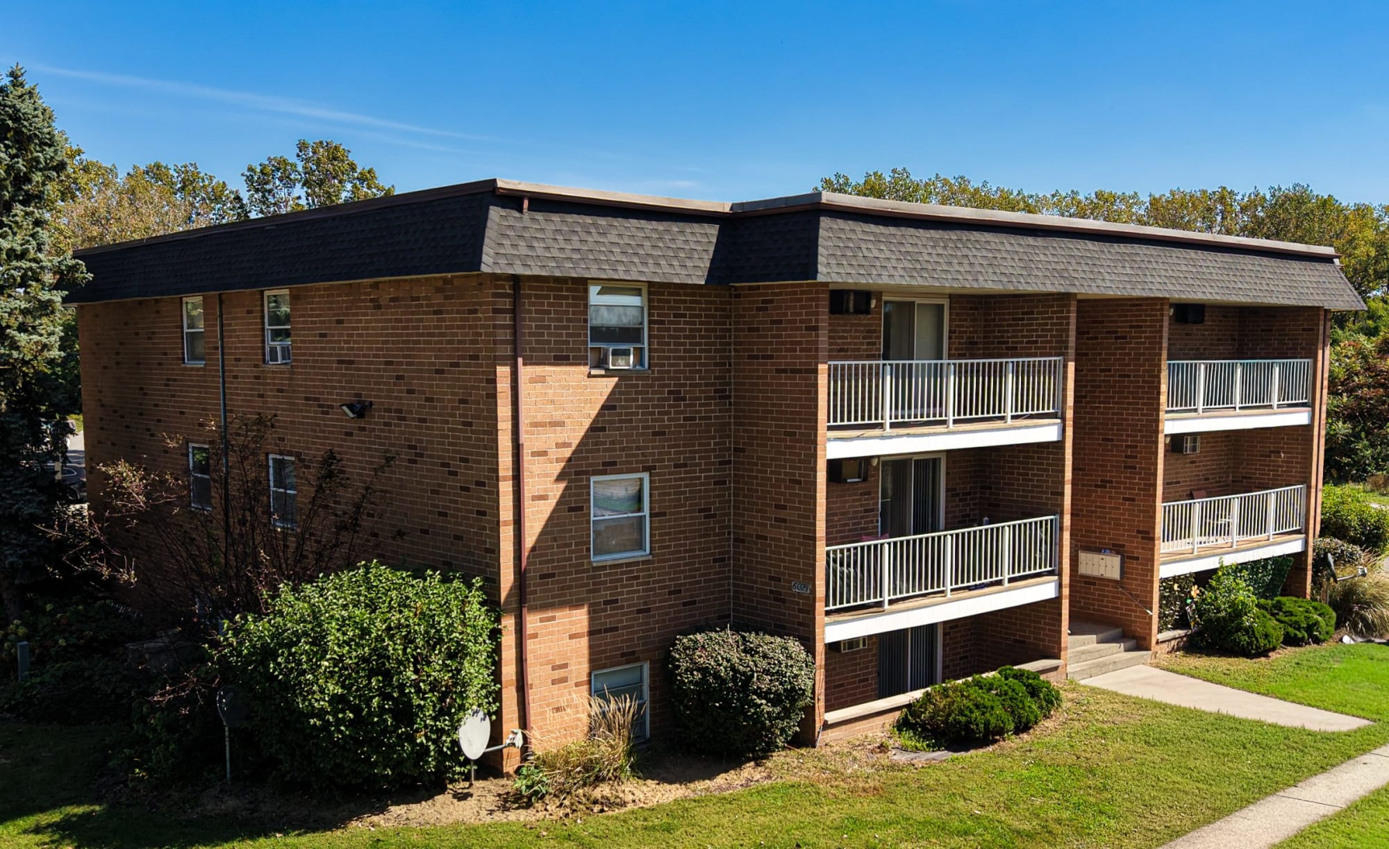Three-story brick building with balconies