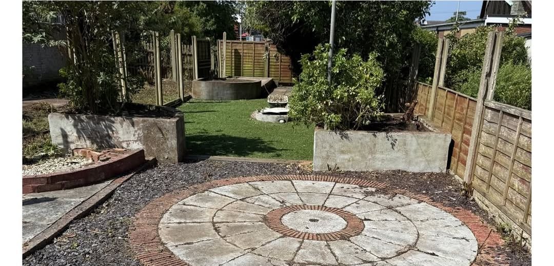 Overgrown garden after clearance with lawn and patio restored