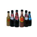 Six bottles of Sid's artisan condiments, including hot sauce, raspberry vinegar, and vinaigrettes.