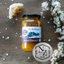 Jar of Taste of the Alps Apricot Kasundi, handcrafted in Central Otago, with honeycomb, blossoms, and NZ Artisan Awards silver medal.