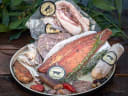 Artisan smoked meats, salmon, and sausages from The Sausage Press Deli Co, Upper Moutere, garnished with rosemary and olives.