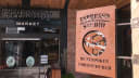 Rustic metal sign for Espresso Studio BY FUSHOKEN at the entrance of Riverside Market, Christchurch, New Zealand.