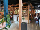 Vibrant indoor market scene with wooden structures, string lights, and diverse food stalls at Riverside Market, Christchurch.