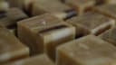 Artisan layered soap bars with dark streaks and salt crystals, handcrafted by Soap Kitchen Wanaka for Queenstown Arts & Craft Market.