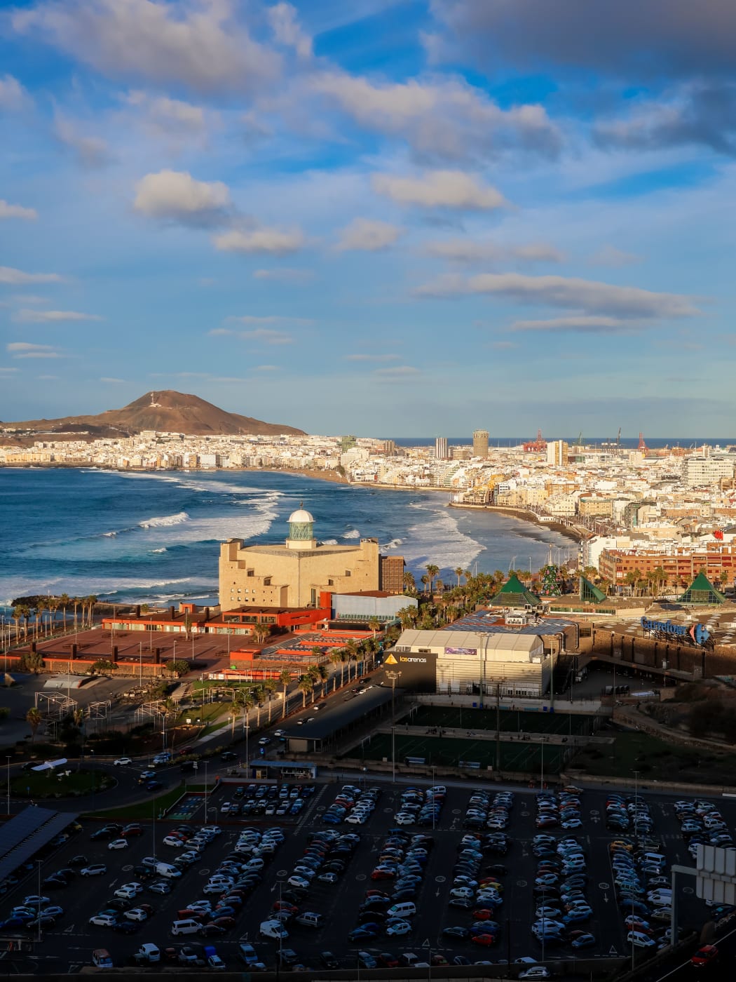 Las Canteras beach curving away from the concert hall towards La Isleta, with surf breaking offshore
