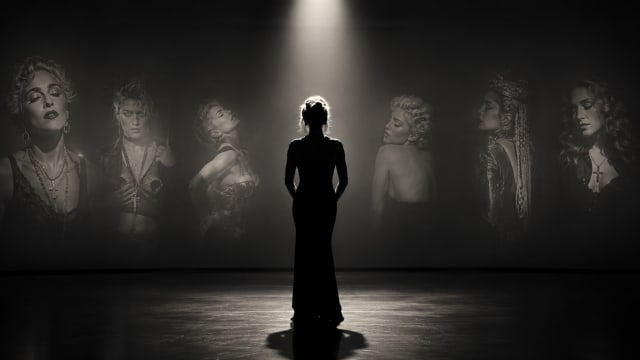 A lone female silhouette stands beneath a dramatic spotlight in a dark gallery-like space. Surrounding her are large, ghostly portraits of different versions of herself, emerging from the shadows like memories or alternate identities. The monochrome composition evokes themes of reinvention, fame, self-creation, and the passage of time. The figure faces away from the viewer, emphasizing mystery and reflection, while the surrounding portraits suggest a life continually rewritten and reimagined.