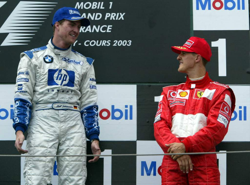 Ralf Schumacher sharing podium with brother Michael Schumacher
