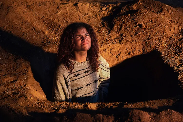 Rue played by Zendaya in HBO's Euphoria digs a grave in a still from the show