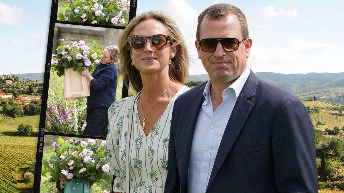 Peter Phillips and Harriet Sperling wearing sunglasses stand in front of a display featuring flowering plants and a rural landscape backdrop.
