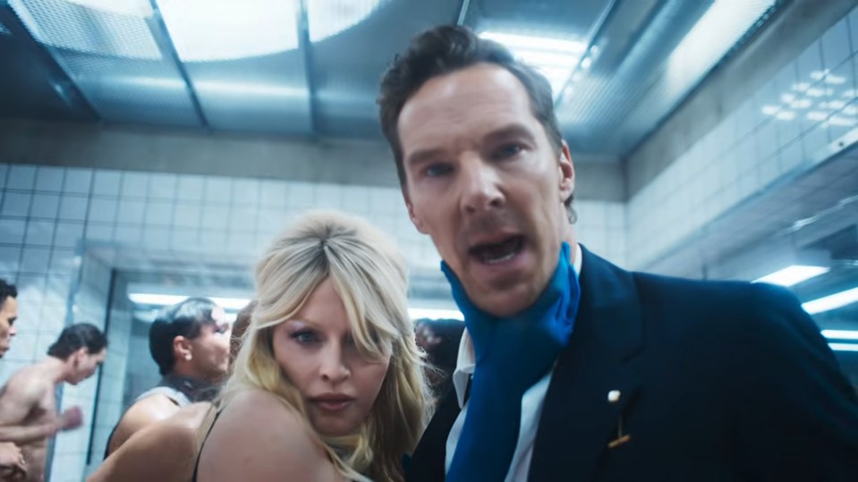 Benedict Cumberbatch in a blue coat and scarf and Madonna look surprised in a still from her Confessions II – The Film music video