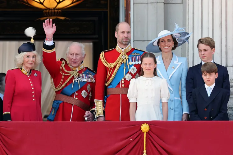 Queen Camilla, King Charles waving, Prince William, Princess Charlotte, Kate Middleton, Prince George, and Prince Louis on the Buckingham Palace balcony at Trooping the Colour.