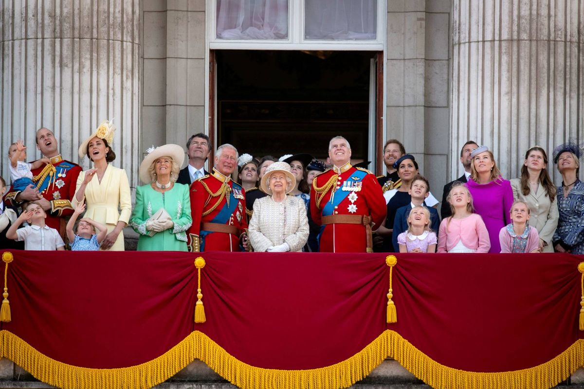 Members of the British Royal Family stand on the Buckingham Palace balcony during Trooping The Colour, wearing formal attire and regalia.