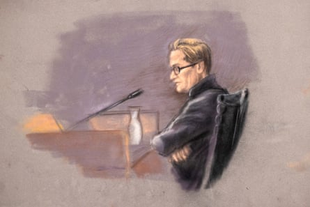 Court sketch of Marius Borg Høiby wearing glasses and a dark jacket, seated at a courtroom desk with arms crossed near a microphone and water pitcher.