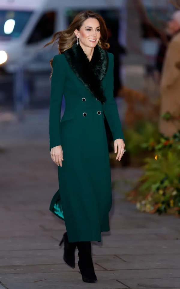 At the 2025 Together at Christmas carol service at Westminster Abbey, she wore a reworn forest green Catherine Walker coat, its collar finished in coordinating Troy London faux fur for festive effect. | Photo: Getty Images