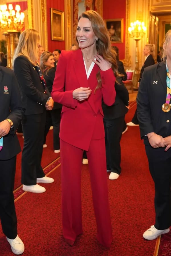 Hosting England's Rugby World Cup champions at Windsor Castle in January 2026, she wore a vivid red Alexander McQueen drop-hem suit — a rewear that also nods pointedly to the team's Red Roses nickname. | Photo: Getty Images