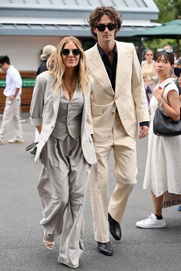 Sienna Miller stepped out in a sharp grey suit and white heels alongside fiancé Oli Green, who kept things sleek in tan tailoring with a black shirt.
