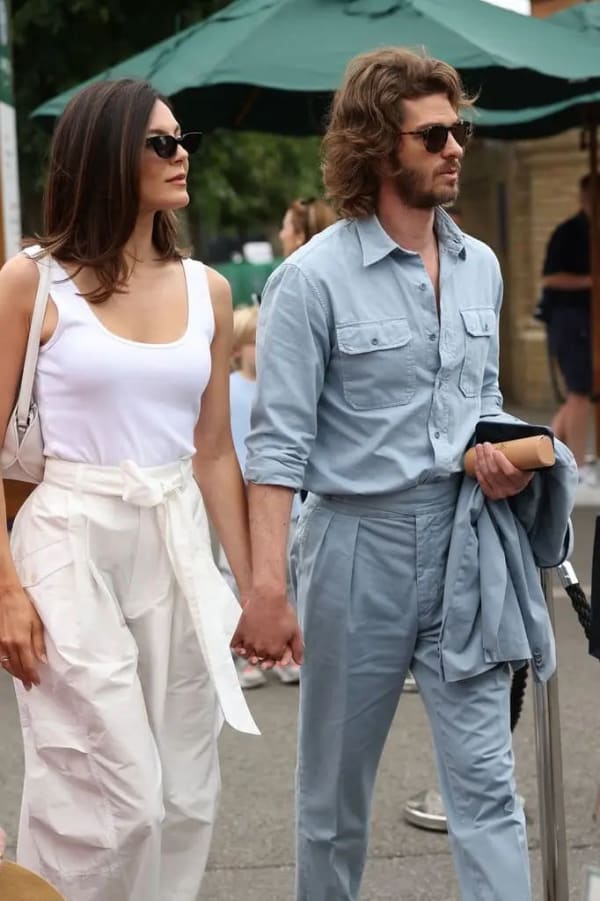 Andrew Garfield and girlfriend Monica Barbaro held hands as they arrived at the tournament, both dressed for the warm weather in relaxed, coordinating outfits.