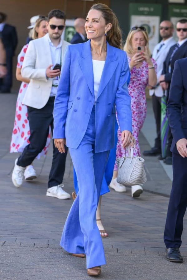 Wimbledon 2026 brought a style curveball: a cobalt Gabriela Hearst linen blazer and wide-leg trousers over a ribbed white top, finished with blue Carousel Jewels earrings and a swept-back ponytail. | Photo: Getty Images