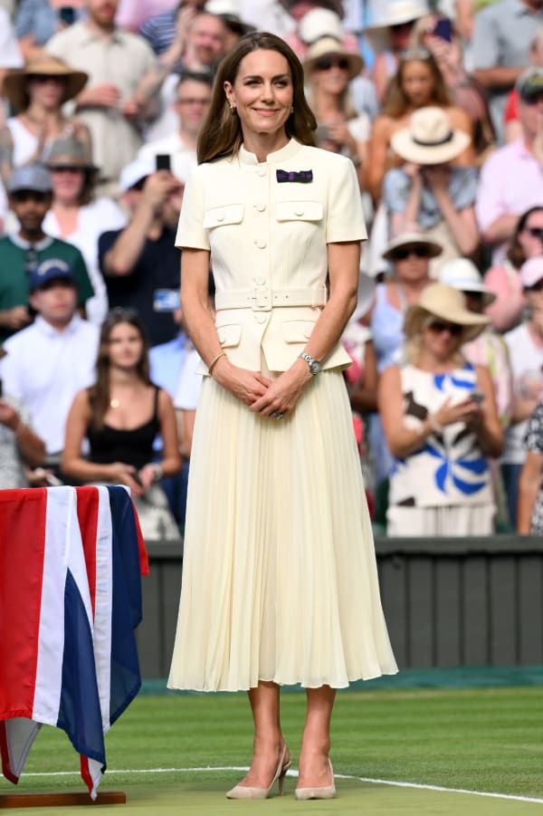 For the 2025 ladies' singles final, the Princess chose a cream Self-Portrait co-ord — a structured utility-style belted top paired with a flowing pleated midi skirt — finishing with her signature AELTC patron's pin. | Photo: Getty Images