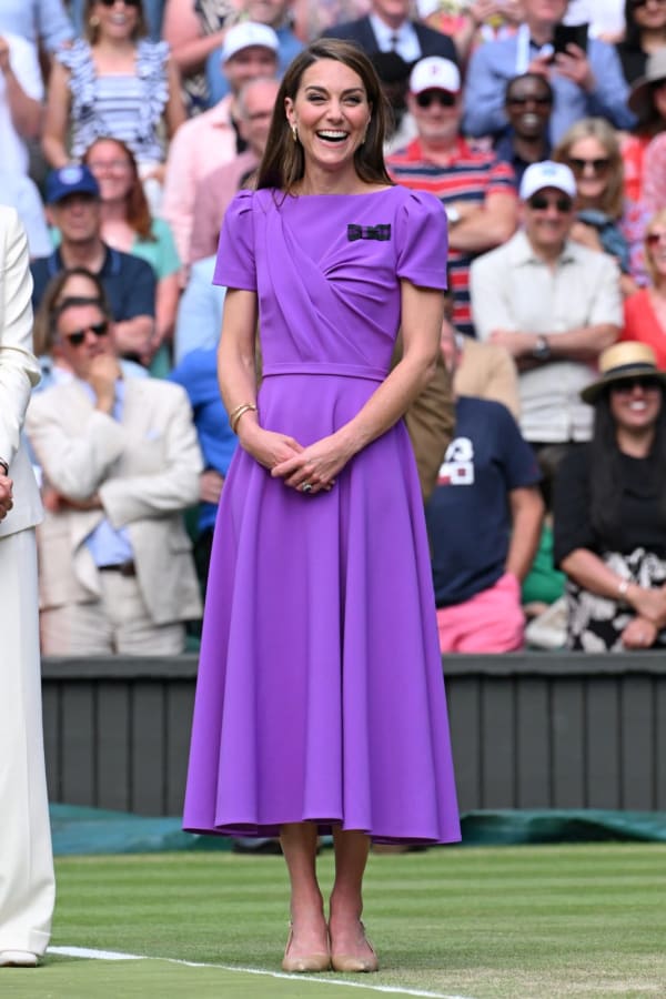 At the 2024 men's singles final — only her second public appearance since announcing her cancer diagnosis — she wore a vivid purple wrap-style Safiyaa midi dress, the hue a deliberate nod to the club's official colours. | Photo: WireImage