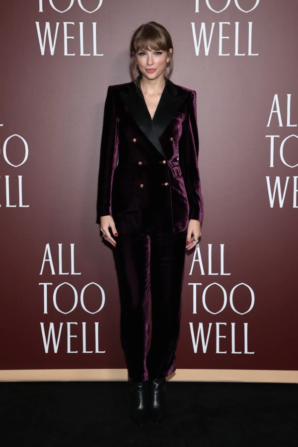 The NYC premiere of the All Too Well short film in 2021 brought a deliberate style pivot — a rich plum double-breasted velvet suit with black satin lapels and gold buttons by Etro, teamed with black ankle boots, announced her arrival in a director era. | Photo: Getty Images