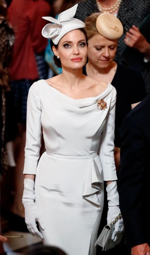 Royal ceremony at St. Paul's Cathedral, 2018 — Wearing a bespoke ivory cowl-neck dress and matching fascinator by Ralph & Russo, complete with elbow-length gloves and a brooch, Jolie looked every inch the occasion-dressing virtuoso.