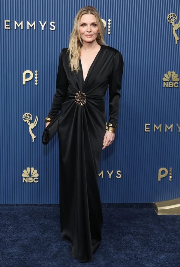 Margo's Got Money Troubles nominee Michelle Pfeiffer took the plunge in a black long-sleeve gown anchored by a jewelled brooch at the waist, finishing the look with gold cuff bracelets. - Getty Images.