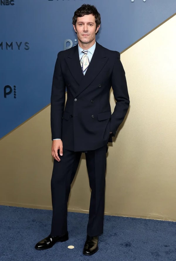 Adam Brody had his own high-fashion moment in an impeccably tailored custom Prada double-breasted suit, teamed with a printed ascot for a playful finishing touch. - Getty Images.