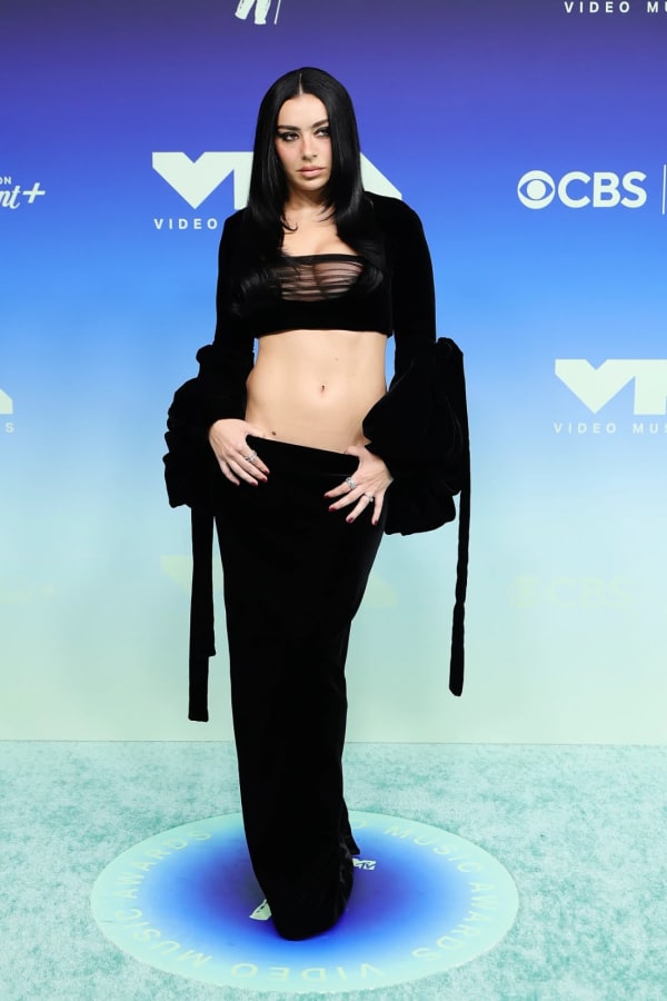 Charli XCX turned heads on the MTV VMAs red carpet in Los Angeles on Sunday in a striking all-black Saint Laurent by Anthony Vaccarello velvet crop top and floor-length skirt.