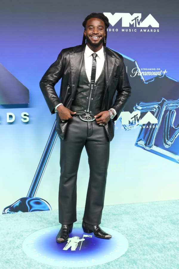 Shaboozey brought undeniable swagger to the 2026 MTV VMAs blue carpet at the Peacock Theatre in Los Angeles, turning heads in a sharp three-piece leather Chrome Hearts suit complete with grills and a statement belt buckle.