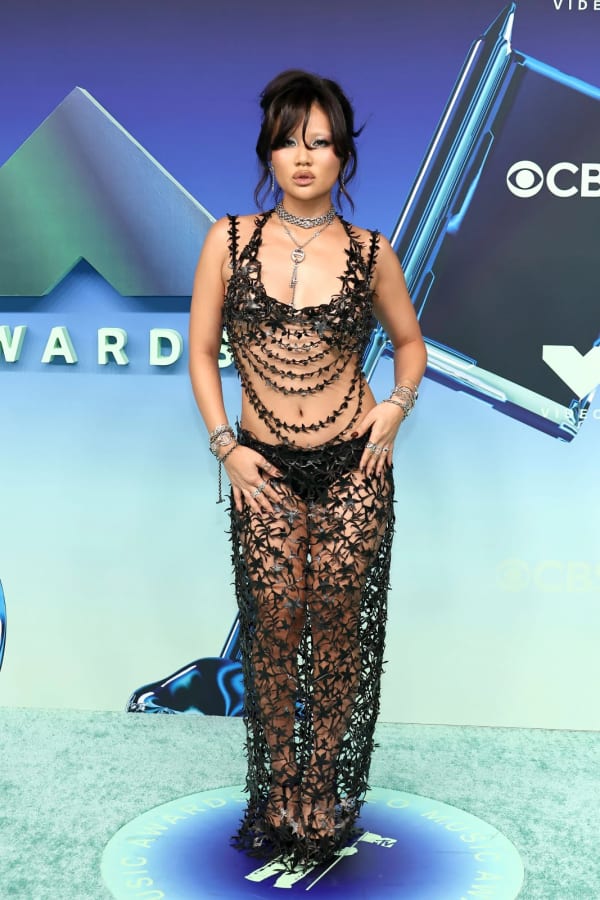 Rei Ami turned heads at the 2026 MTV VMAs at the Peacock Theater in Los Angeles, wearing a daring sheer black Hilá ensemble of appliqué top and maxi trousers, dripping in Hoorsenbuhs jewellery.