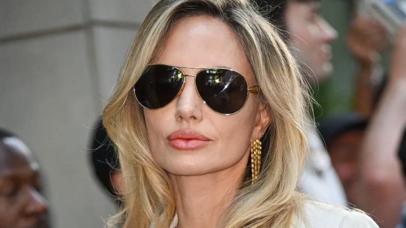 Angelina Jolie attends a public event, photographed from the front in a formal setting