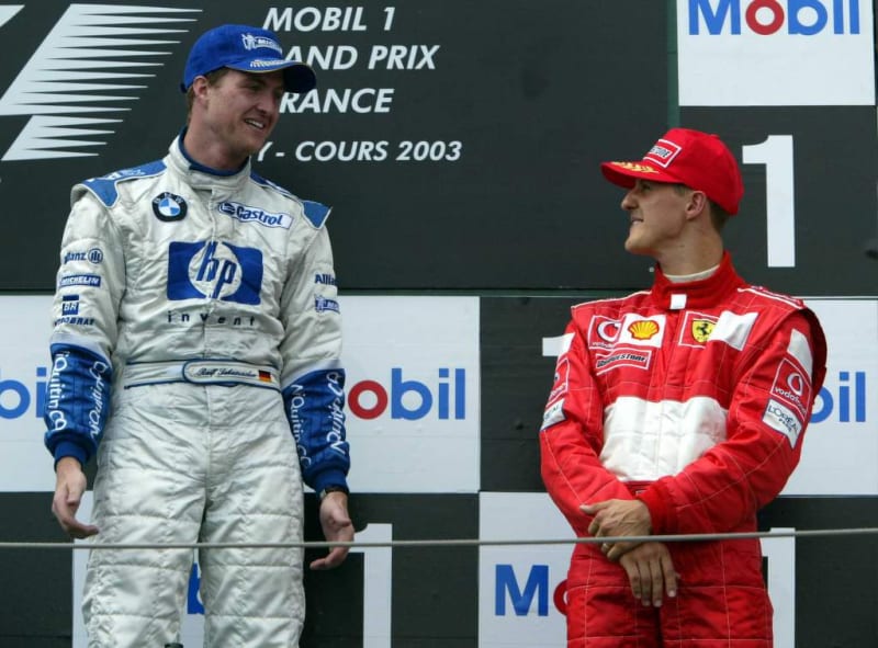Ralf Schumacher sharing podium with brother Michael Schumacher