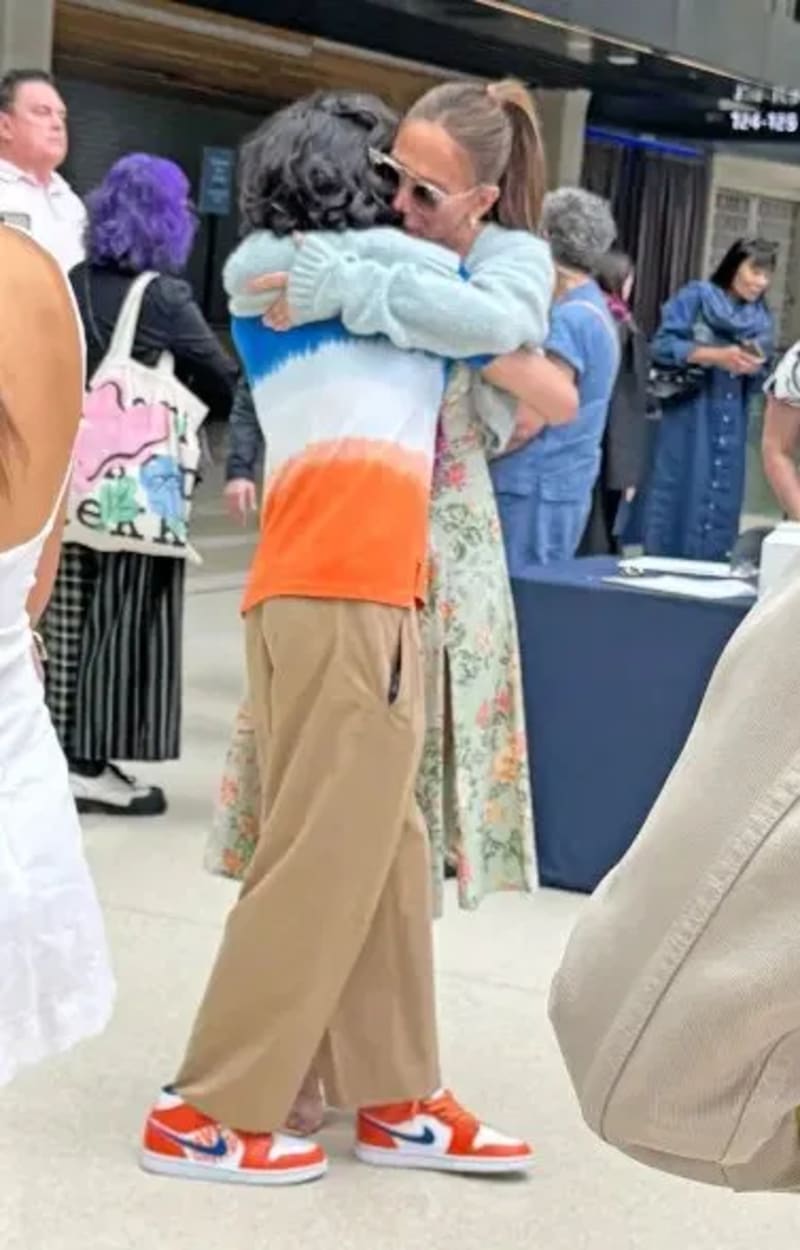 Jennifer Lopez hugging her son Max at a graduation ceremony.