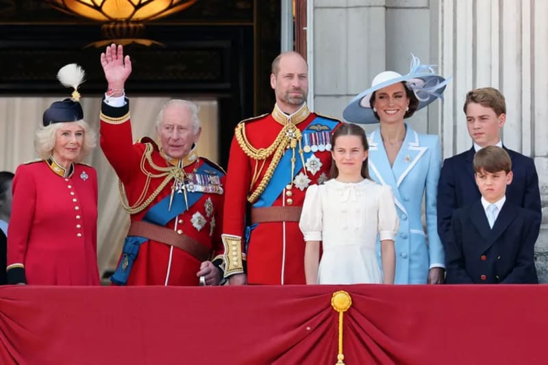 Queen Camilla, King Charles waving, Prince William, Princess Charlotte, Kate Middleton, Prince George, and Prince Louis on the Buckingham Palace balcony at Trooping the Colour.