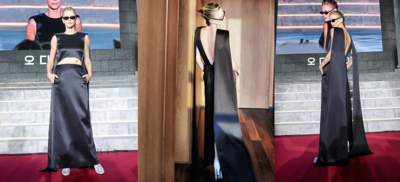 A blonde woman wearing black rectangular sunglasses and a sleeveless black satin cutout gown with hands in pockets stands on a red carpet in front of a large screen displaying Korean text; center panel shows the same woman viewed from behind in a mirror reflection revealing the deep open back of the gown in an indoor setting with wood flooring; right panel shows the same woman from behind on the red carpet with the gown's dramatic cape-like panels visible against a cinematic backdrop.