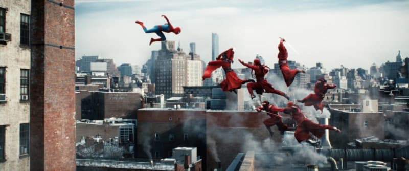 Multiple Spider-Man figures in red suits leap and fly across a New York City rooftop with the skyline visible behind them.