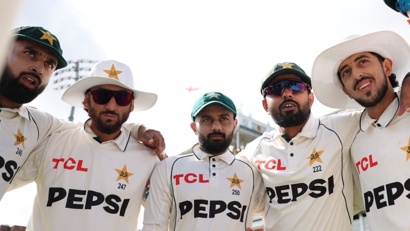 Five cricket players in Pakistan Test team uniforms with TCL and Pepsi sponsorships pose together outdoors.