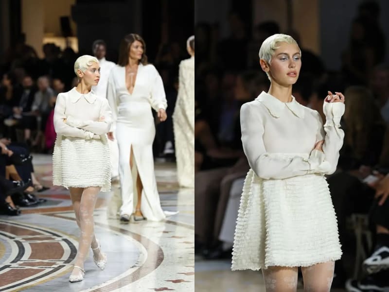 Two runway photos: woman in white blouse and ruffled mini skirt, arms crossed walking; close-up of same outfit on fashion show runway.