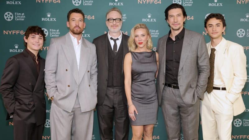Six people posing in formal attire at a NYFF64 Film at Lincoln Center step-and-repeat backdrop.