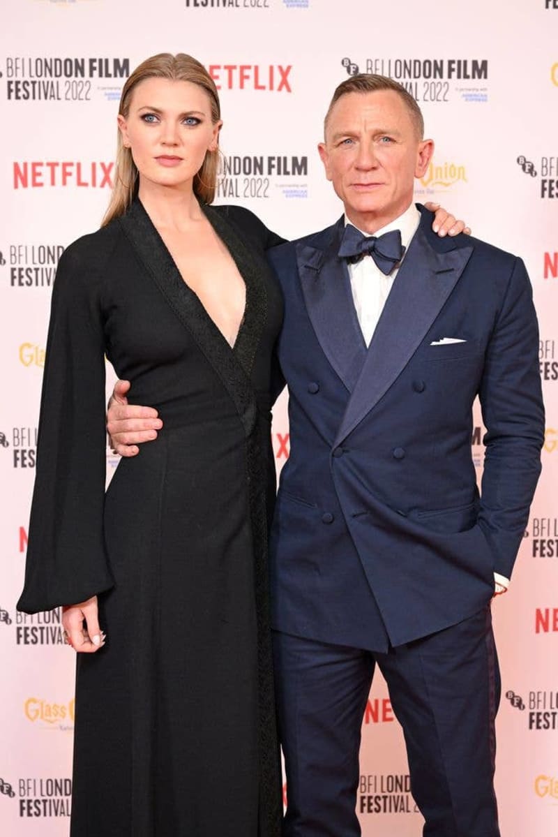 Two elegantly dressed people pose together at the BFI London Film Festival 2022, with Netflix branding visible in the background.