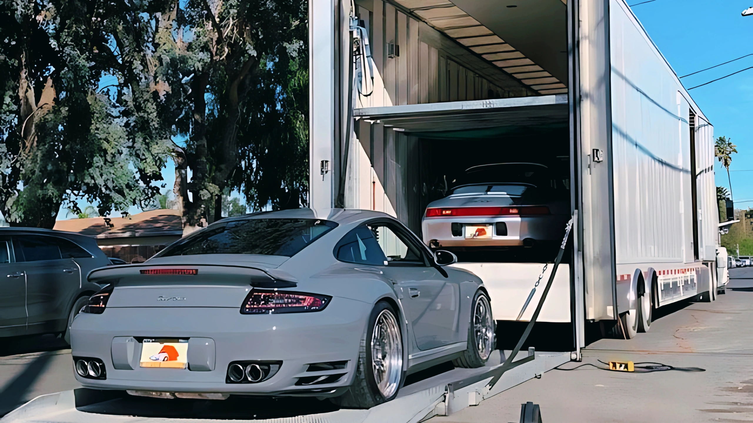 Enclosed auto transport trailer protecting luxury vehicle – Secure car shipping by Rapid Auto Shipping