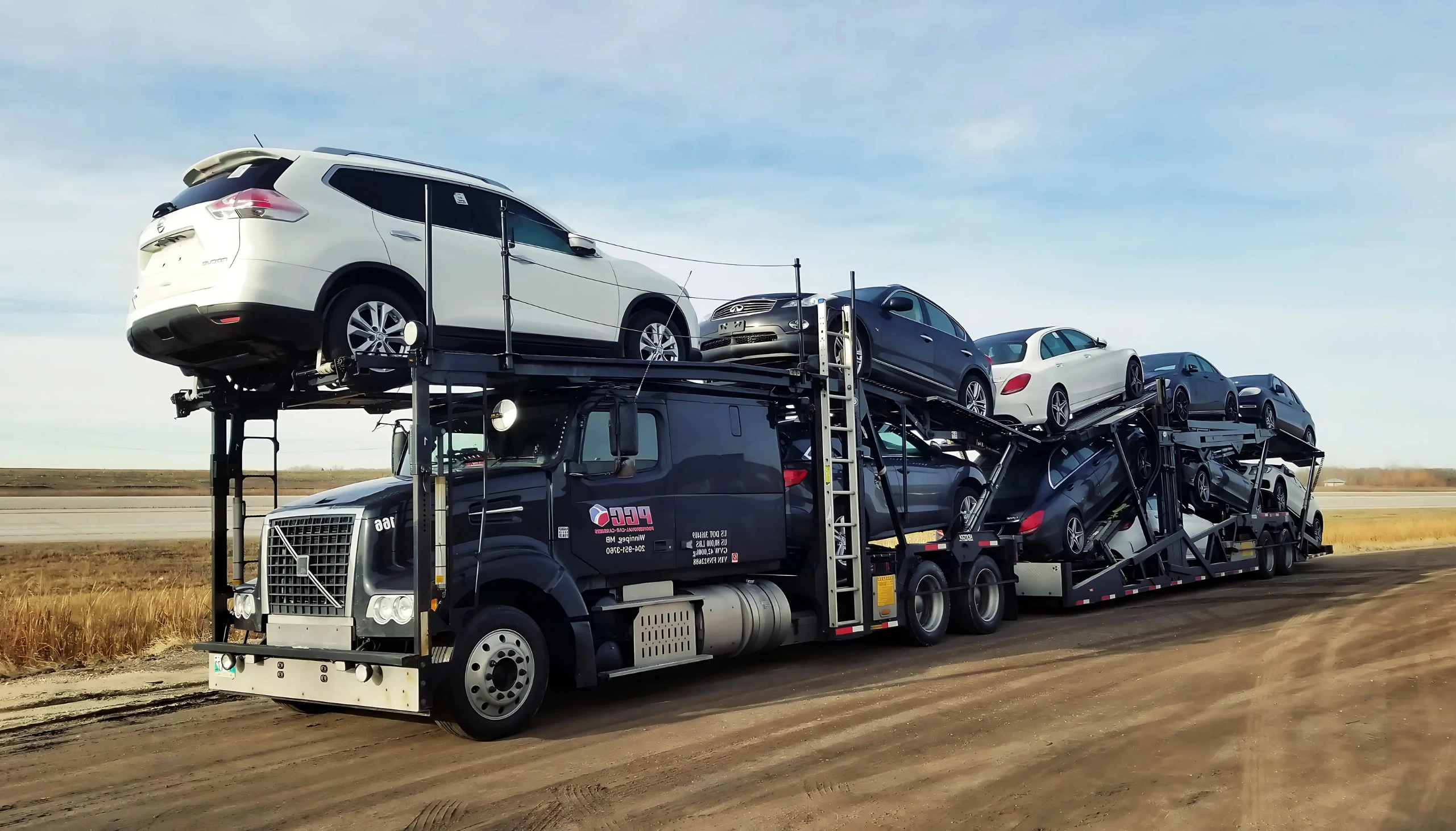 Open auto transport carrier loading multiple vehicles – Rapid Auto Shipping cost-effective car shipping solution