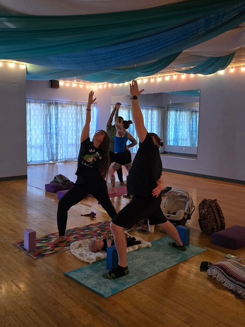Expectant mother practicing prenatal yoga